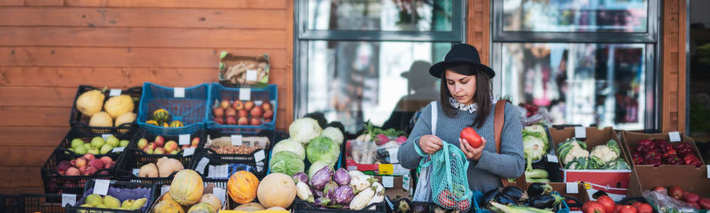 A woman shopping for produce near Five7Five in Austell, Georgia