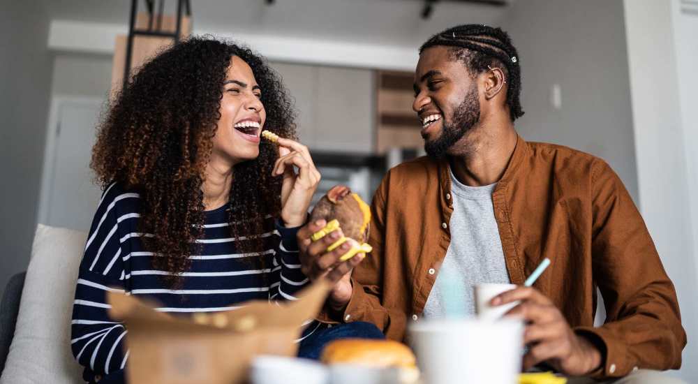 Resident couple eating takeout at Tristan Townhomes in Garden City, Georgia