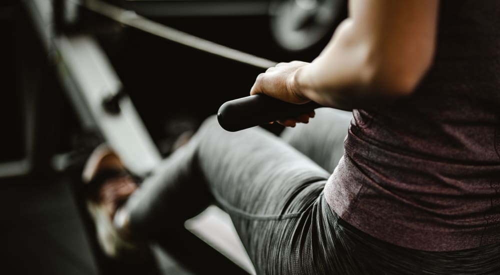 Resident using a rowing machine in the fitness center at Eight Mile House in Stockton, California