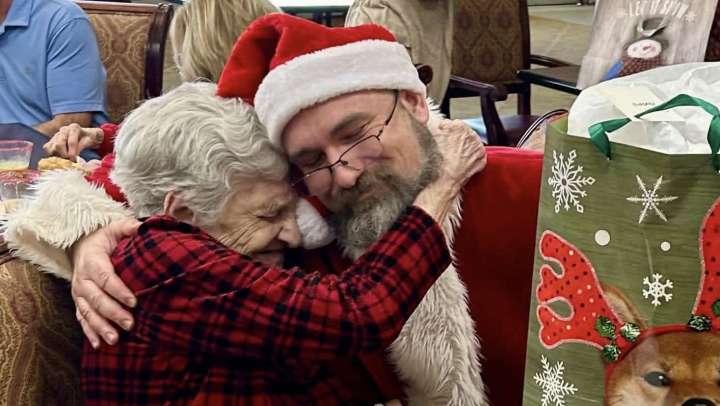 Female resident giving Santa a big hug