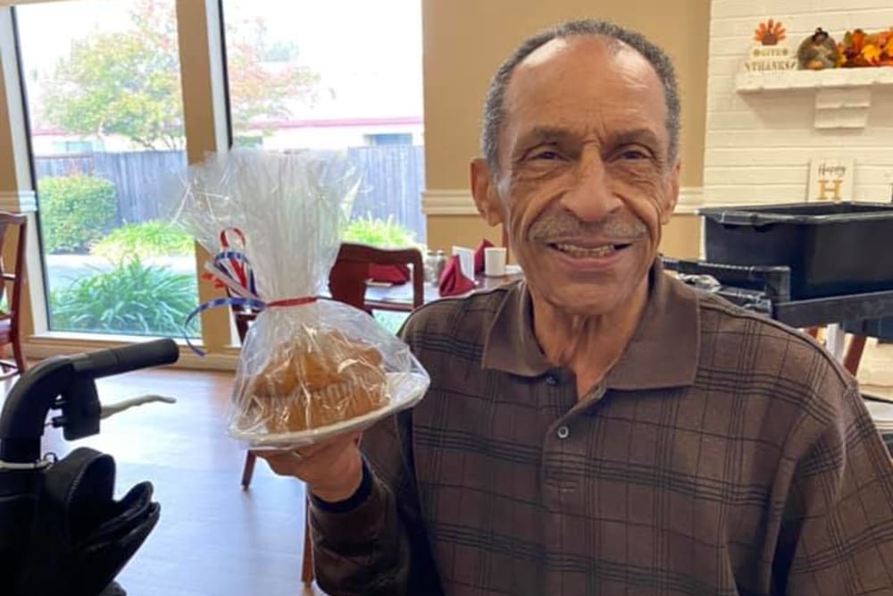 Resident holding a plate of food at Lodi Commons Senior Living in Lodi, California