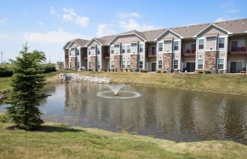 Apartment exterior and water attraction at Woodland Reserve