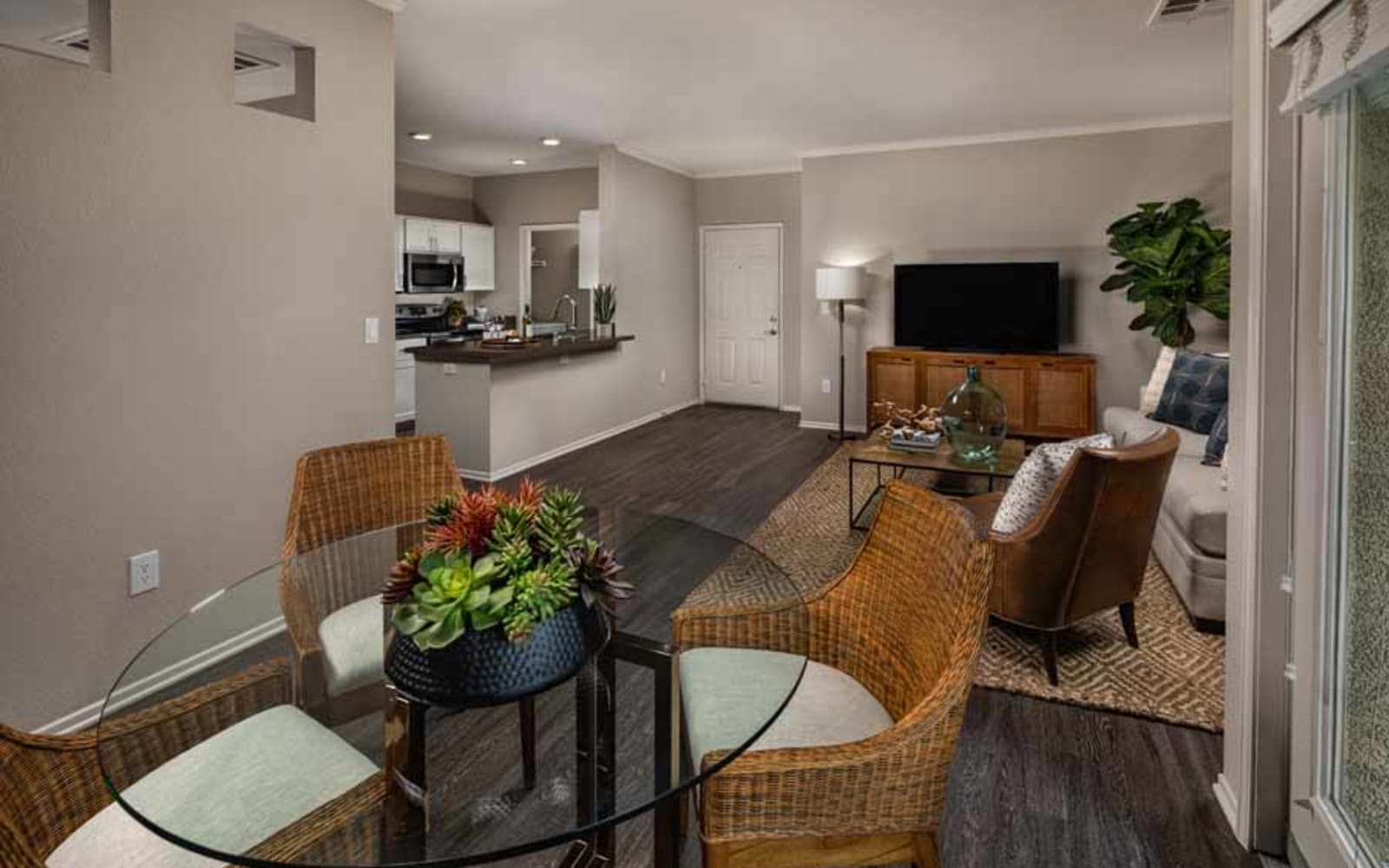 Wood flooring in an apartment dining room and living room at Castlerock at Sycamore Highlands in Riverside, California