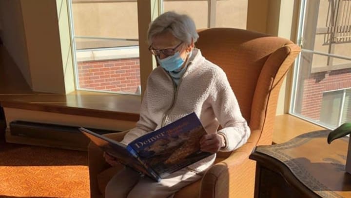 Older woman reading about Denver