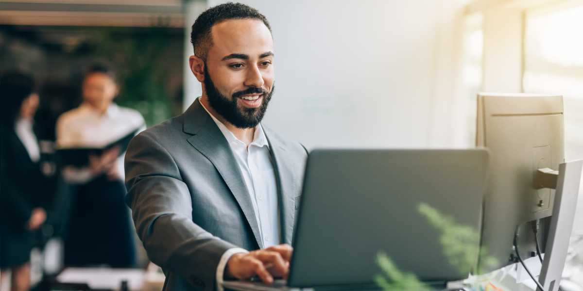 Employee on his laptop at Lauth Communities in Carmel, Indiana