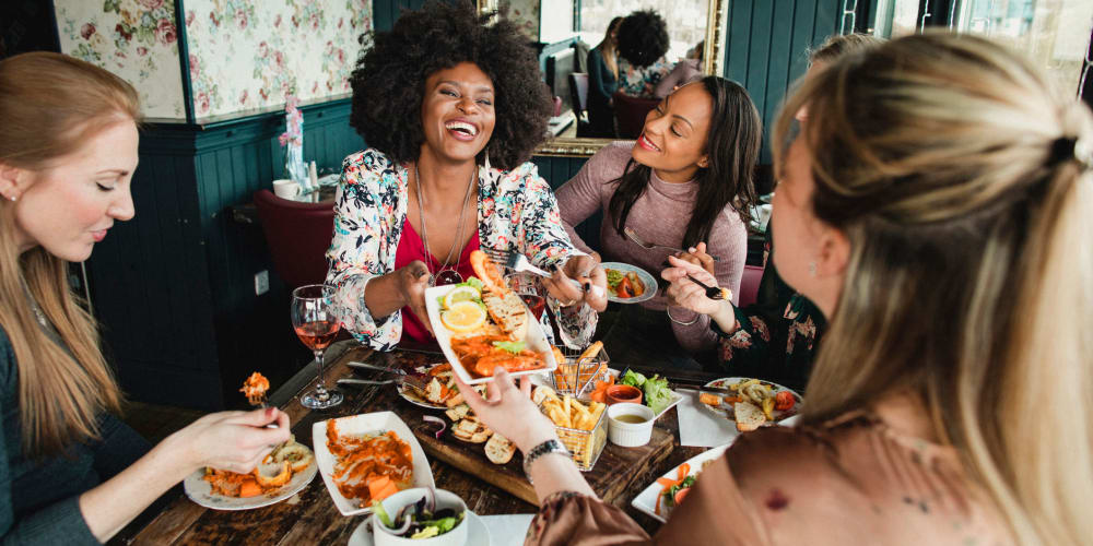 A group of friends sharing food near Vesta Bouldercrest in Atlanta, Georgia