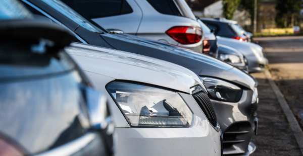 Parking lot with various cars lined up near Valley Brook Townhomes in Rochester, New York