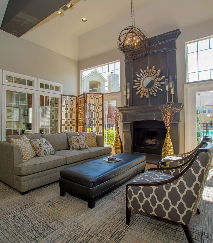 Elegant lounge area with fireplace and armchairs at Villas at Aspen Park in Broken Arrow, Oklahoma