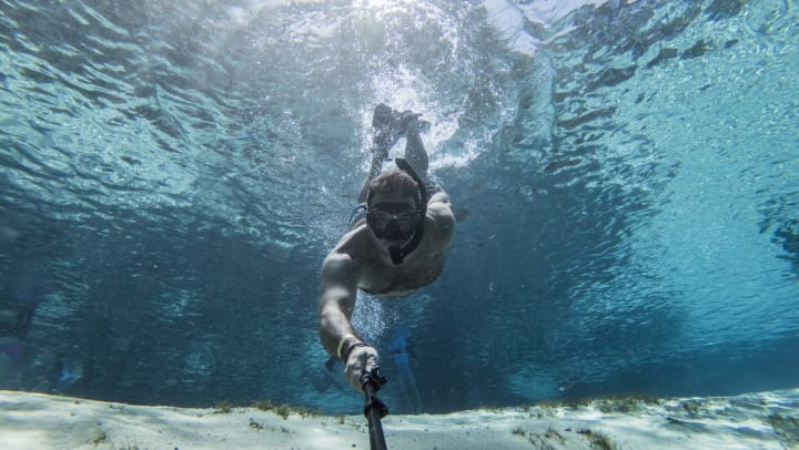 Man diving underwater in Jacksonville, Florida near Wimberly at Deerwood