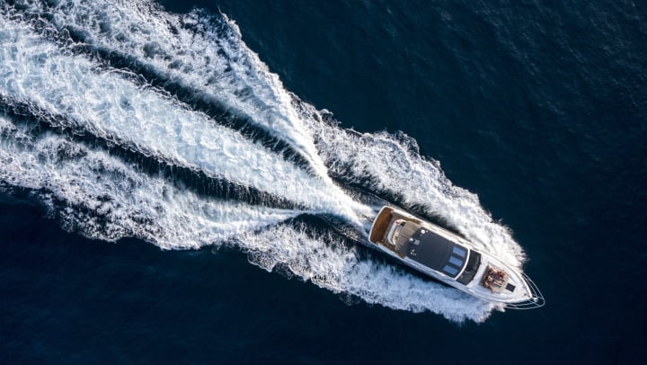 An aerial shot of a motor boat on a sunny day.