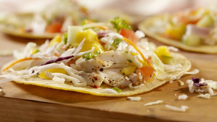 Closeup of grilled fish tacos with pineapple slaw