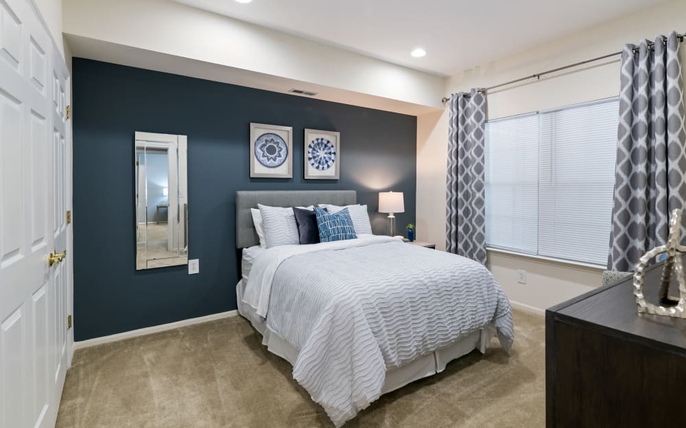Model bedroom with ensuite bathroom and walk-in closet at Woodview at Marlton Apartment Homes in Marlton, New Jersey