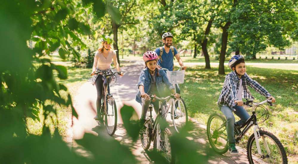 Resident family biking near The Pointe at Loudon in Loudon, Tennessee