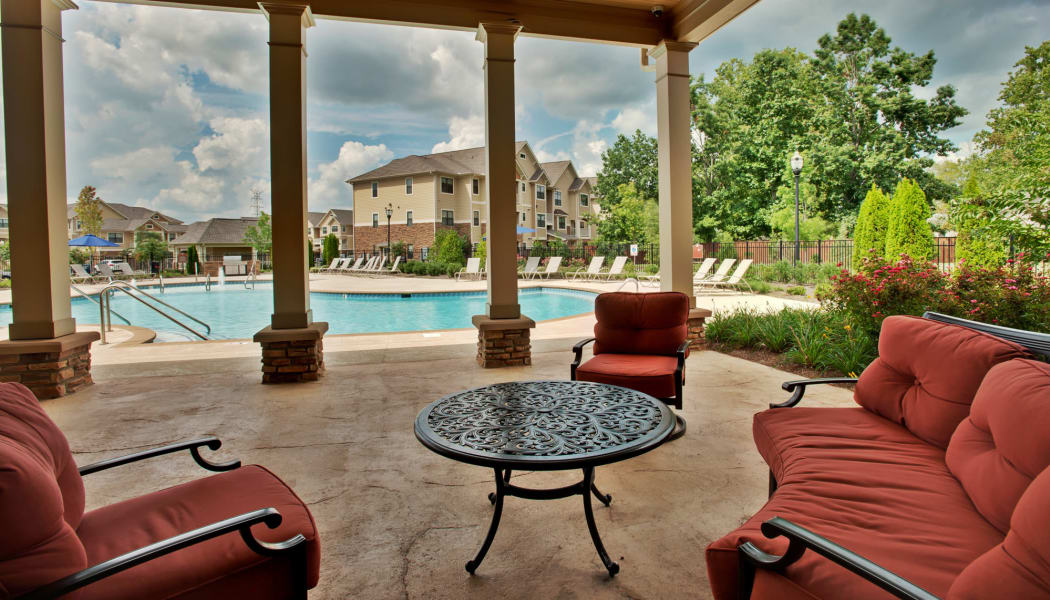 Comfortable and shaded seating area near the pool at Richland Falls in Murfreesboro, Tennessee