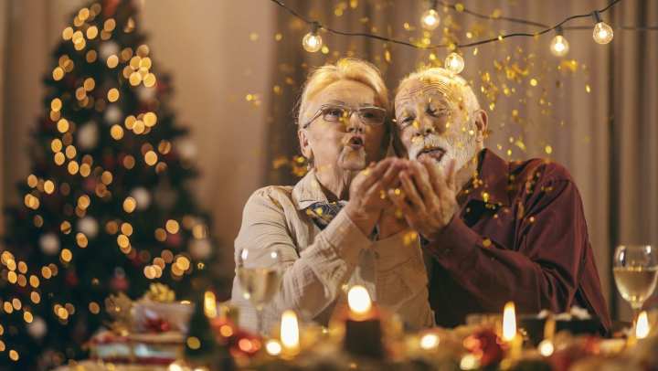 Old woman and man blowing glitters