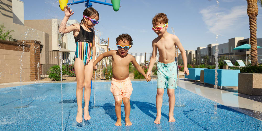 Happy kids in swimming pool at Las Casas at Windrose in Litchfield Park, Arizona