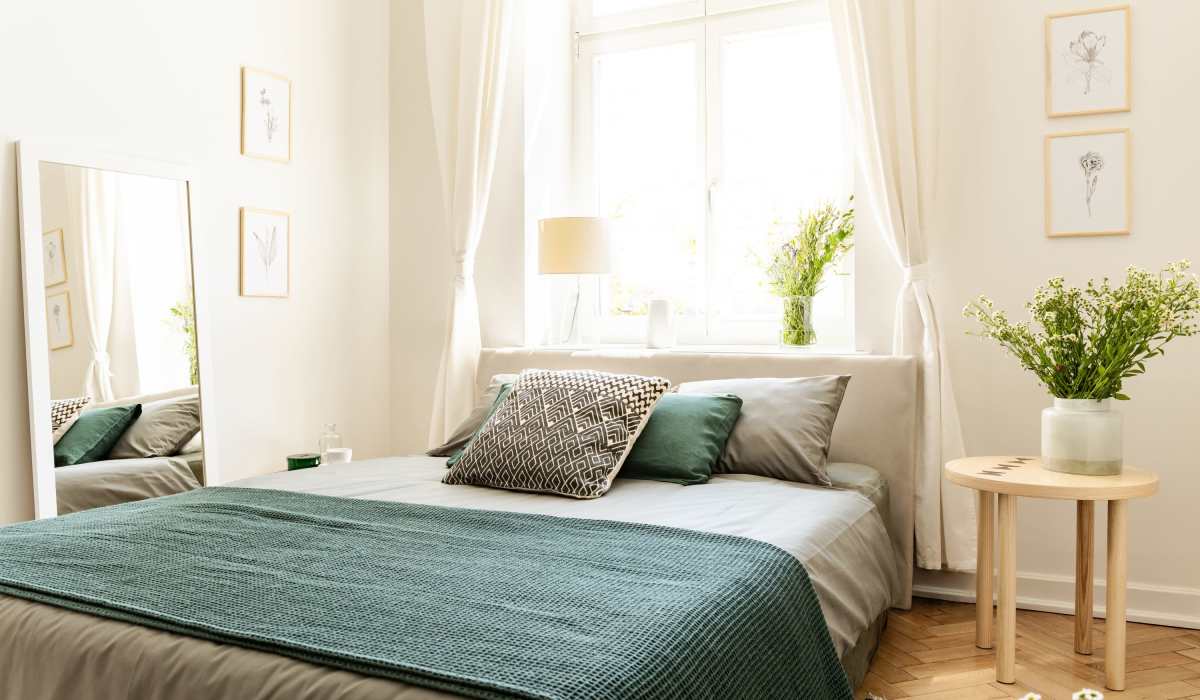 Bright bedroom with king size bed and large window at Chinook Way Apartments in Fairview, Oregon