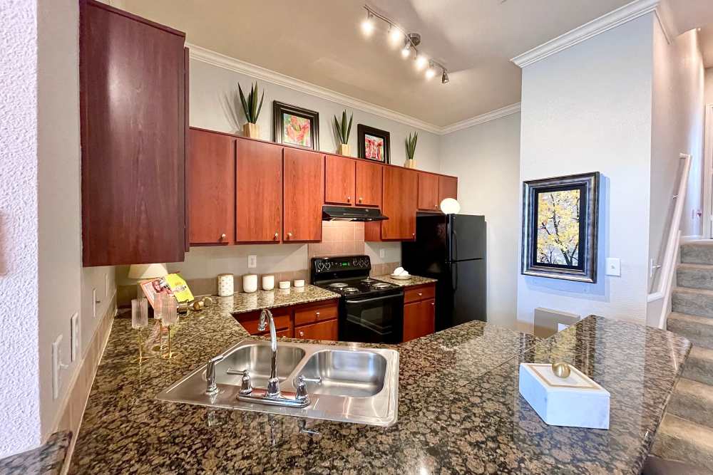 Kitchen with granite countertops at The Abbey at Stone Oak in San Antonio, TX