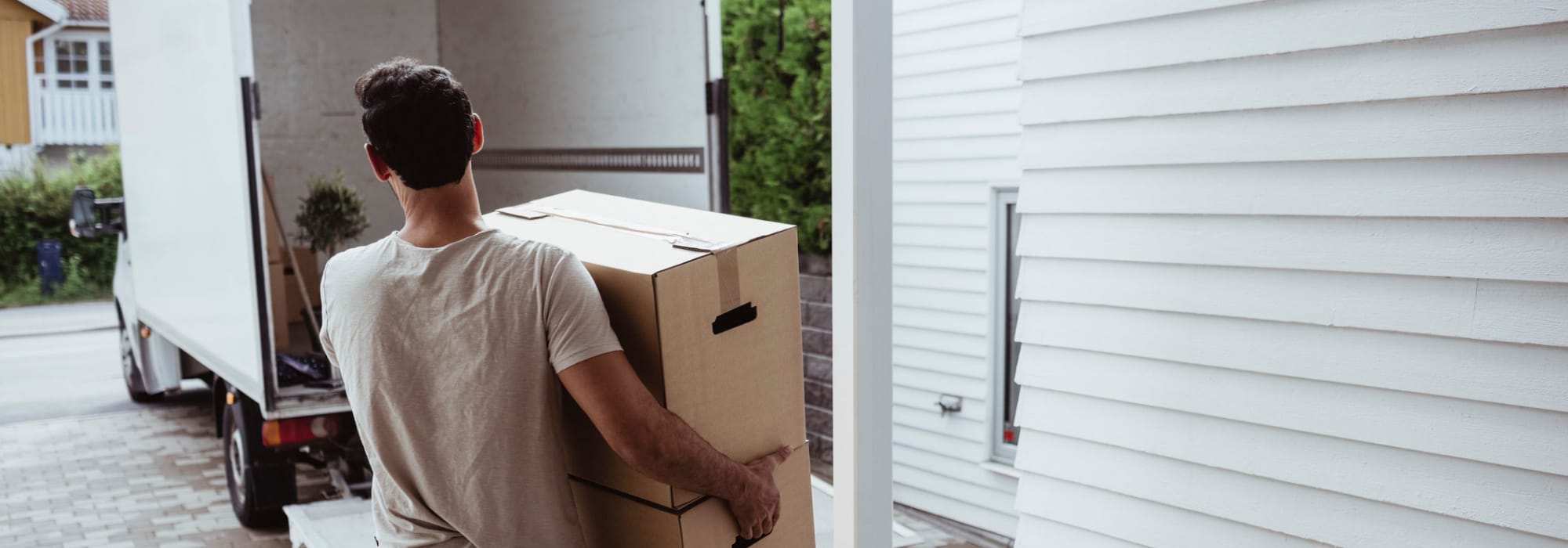 A man moving boxes into a moving truck near Apple Self Storage - Sudbury in Sudbury, Ontario