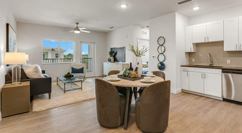 Open kitchen and living room with wood-style flooring at Grand Oak Apartments in Largo, Florida