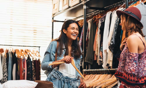 Two women shopping in a clothing store near Residence at Riverside in Austell, Georgia