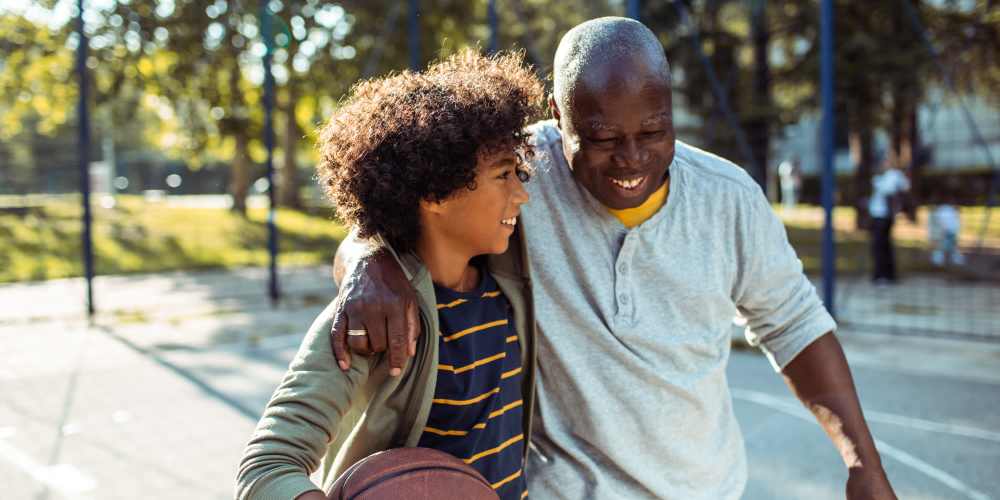 Resident with his kids in sports lawn at Desert Meadows in Lancaster, California