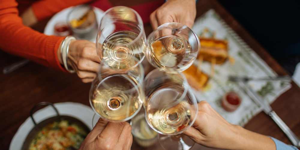 A group of friends toasting glasses near One Belmar Place in Lakewood,Colorado