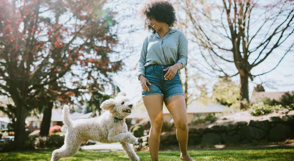 Resident with her dog in park near Fairway in South San Francisco, California