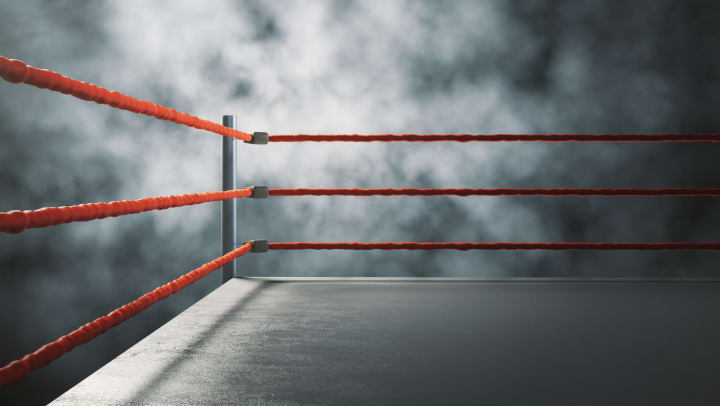 Wrestling ring with red ropes, foggy background