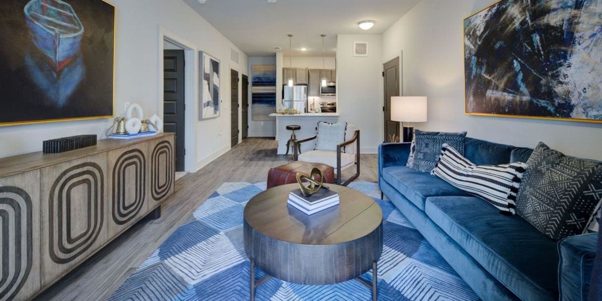 Well-furnished living area with hardwood floors in a model home at Palmetto Pointe in San Antonio, Texas