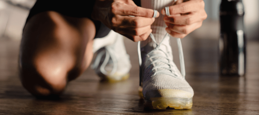 Person tying their shoes in the gym at Reserve at the Ballpark in Atlanta, Georgia