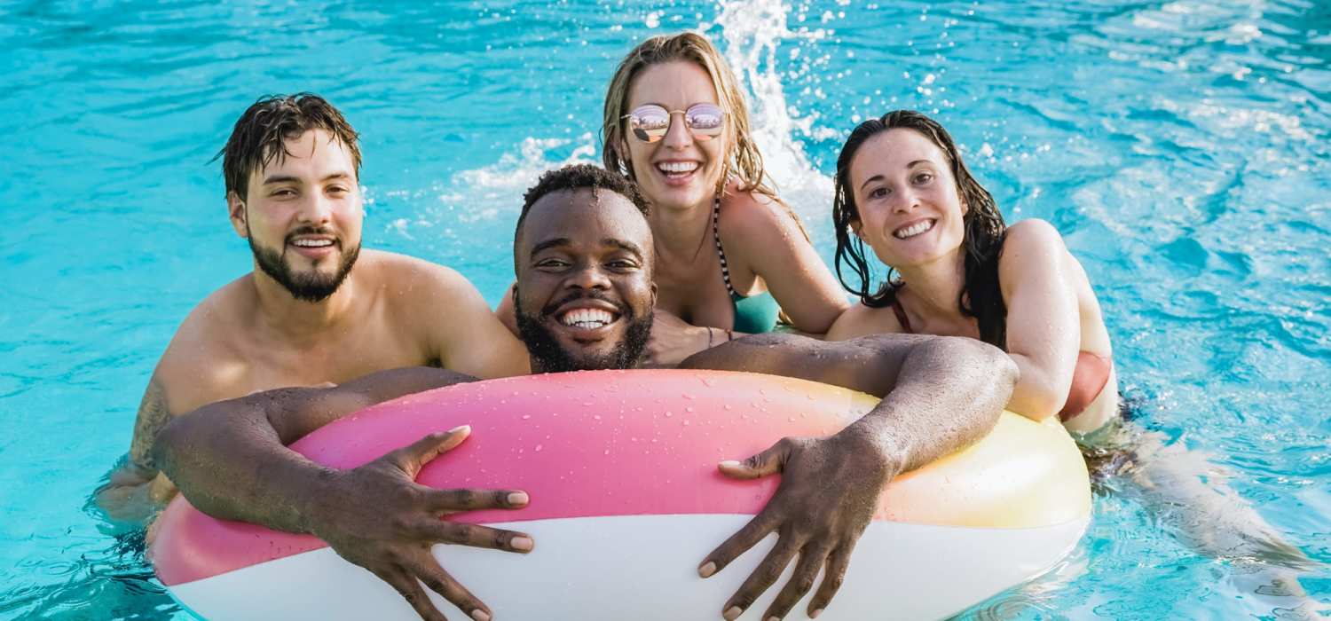 Friends hanging out in the pool at Steeple Chase Apartments in Peoria, Arizona