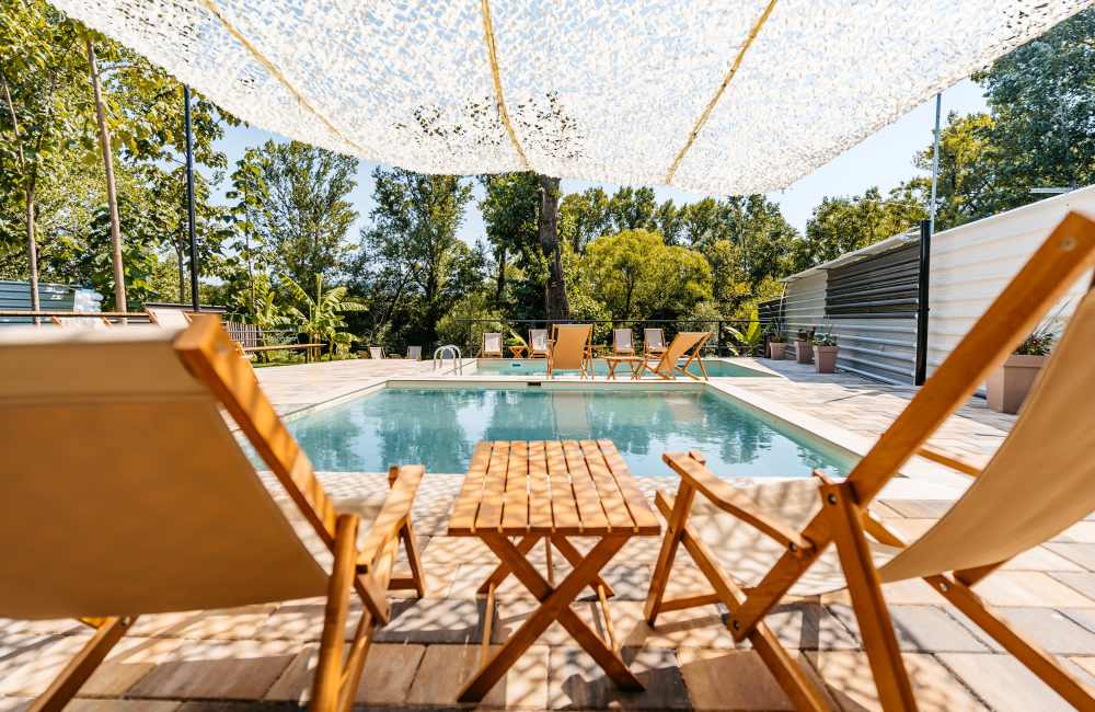 Swimming pool with lounge seating at Villas At Millbrook in Fresno, California