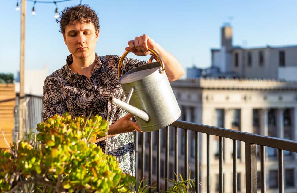 Resident watering plants in her private balcony at Cypress Trace in Brandon, Florida