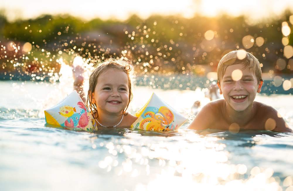 Children playing in swimming pool at Stonebridge Crossing Apartment Homes in Cordova, Tennessee