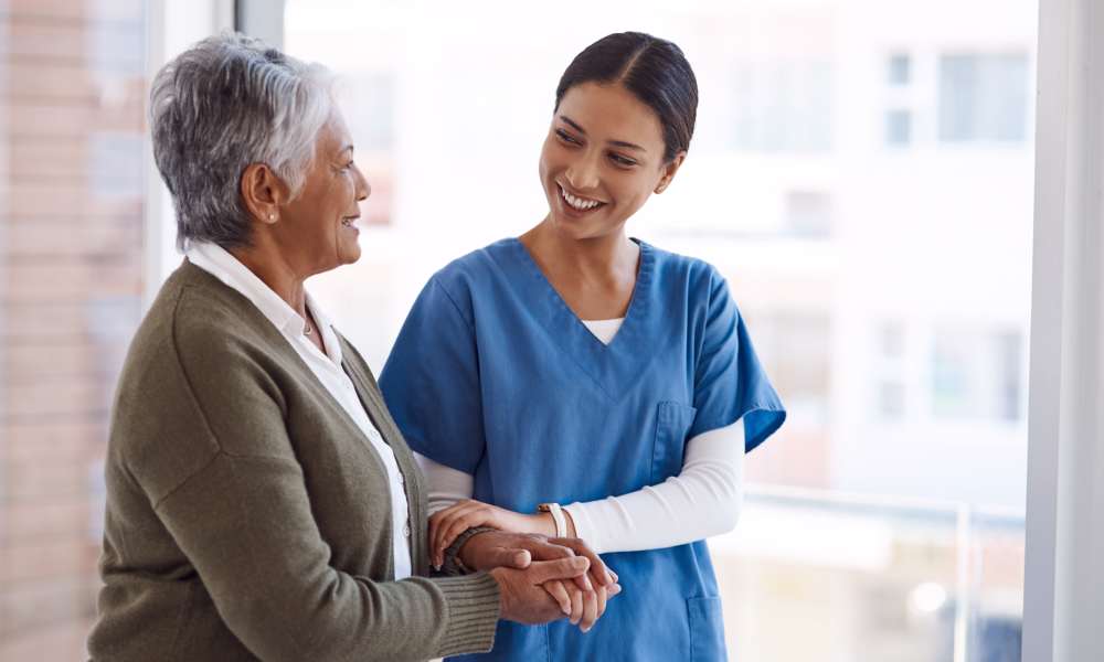 A staff member walking with a patient of Careage at Home in Bellevue, Washington. 