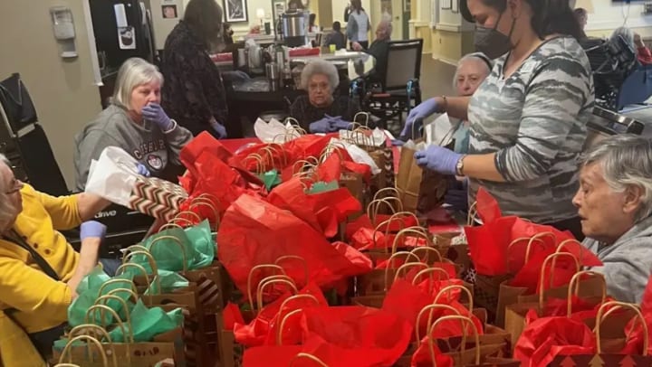 Greenridge Place Memory Care Residents gift cookie bags to staff in Westminster Colorado