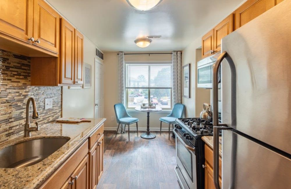 Contemporary kitchen with stainless steel appliances and tile backsplash at Chesapeake Glen Apartment Homes in Glen Burnie, MD