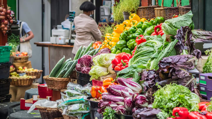 A farmers market vegetable stand with a vibrant selection of produce