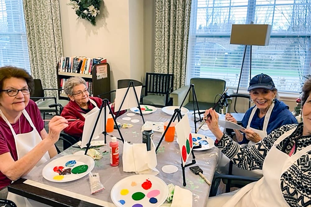 Residents participating in a painting activity at Anthology of The Arboretum in Austin, Texas