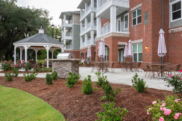 Outdoor barbecue with seating area and gazebo at Harmony at Eagles Landing in McDonough, Georgia