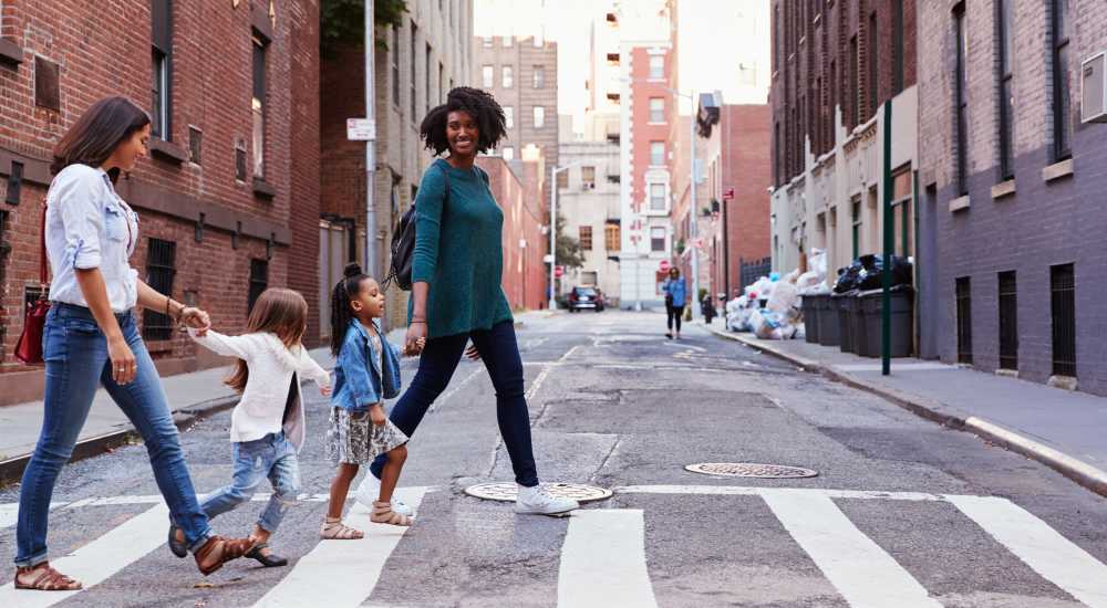 Residents crossing road in downtown near Grandview South Homes in Pittsburgh, Pennsylvania