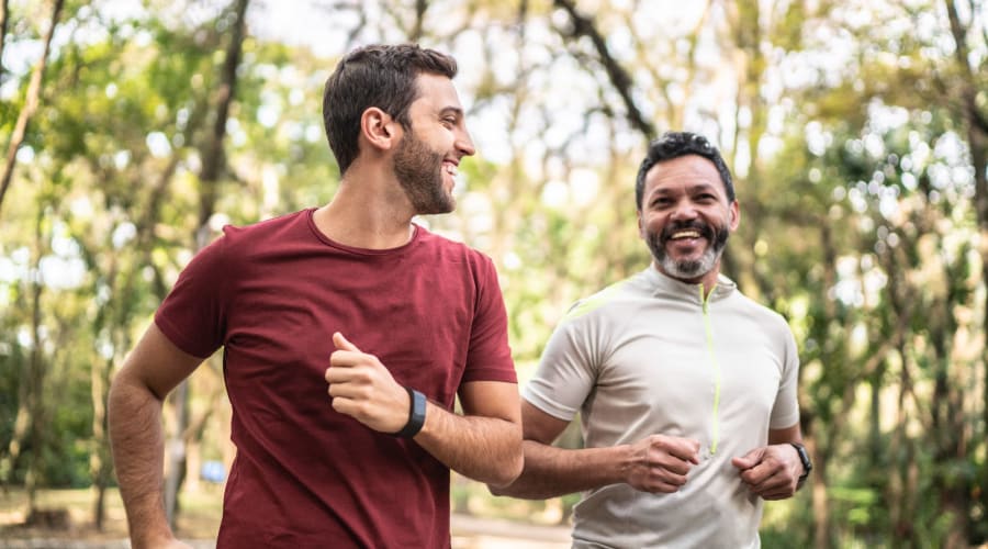 Friends running through the park at Country Oaks Apartments in Hixson, Tennessee