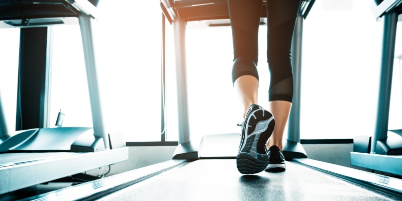 A resident walking on a treadmill at the fitness center at San Onofre I in San Clemente, California