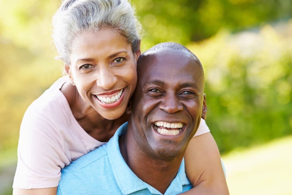 Two residents outside smiling at Atlas Point at Prestonwood in Carrollton, Texas.