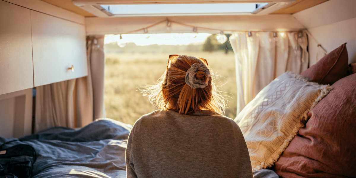 A woman waking up in an RV vehicle from Stayton Mini Storage in Stayton, Oregon