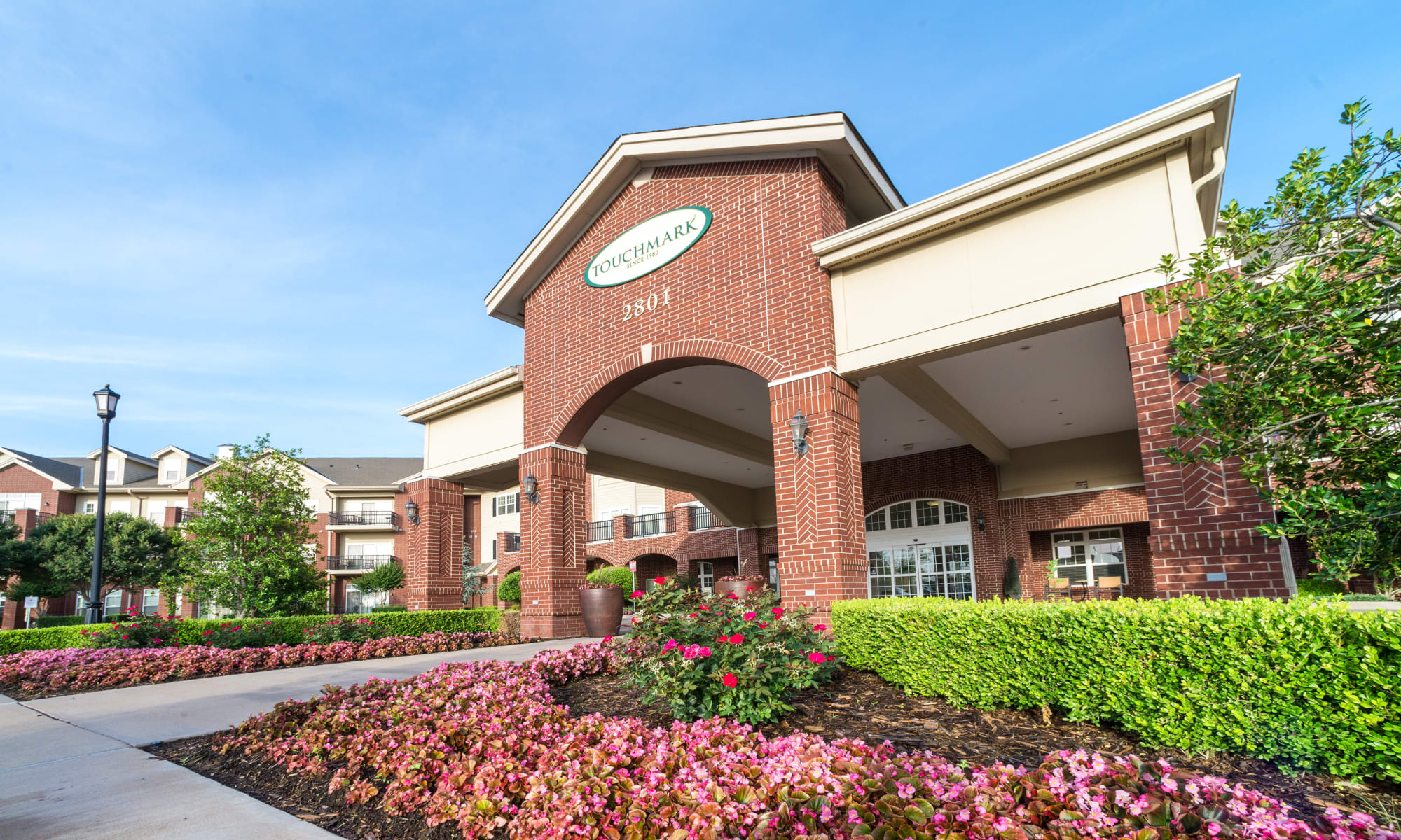 The building exterior and main entrance at Touchmark at Coffee Creek in Edmond, Oklahoma