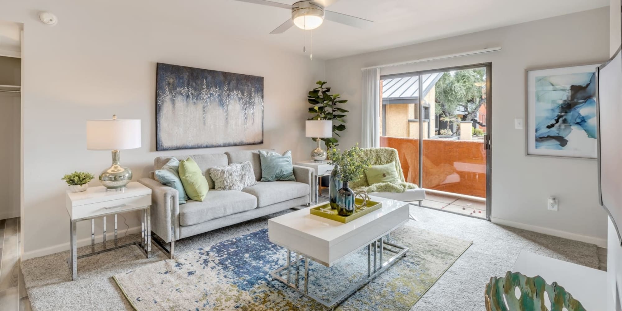 Model living room opening onto a private patio at Onnix in Tempe, Arizona