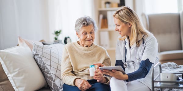 Resident receiving medication assistance from caregiver at Montello Care Center in Montello, Wisconsin