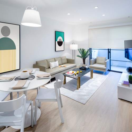 Spacious living room with dining table at Luxe Villas in Brentwood, California